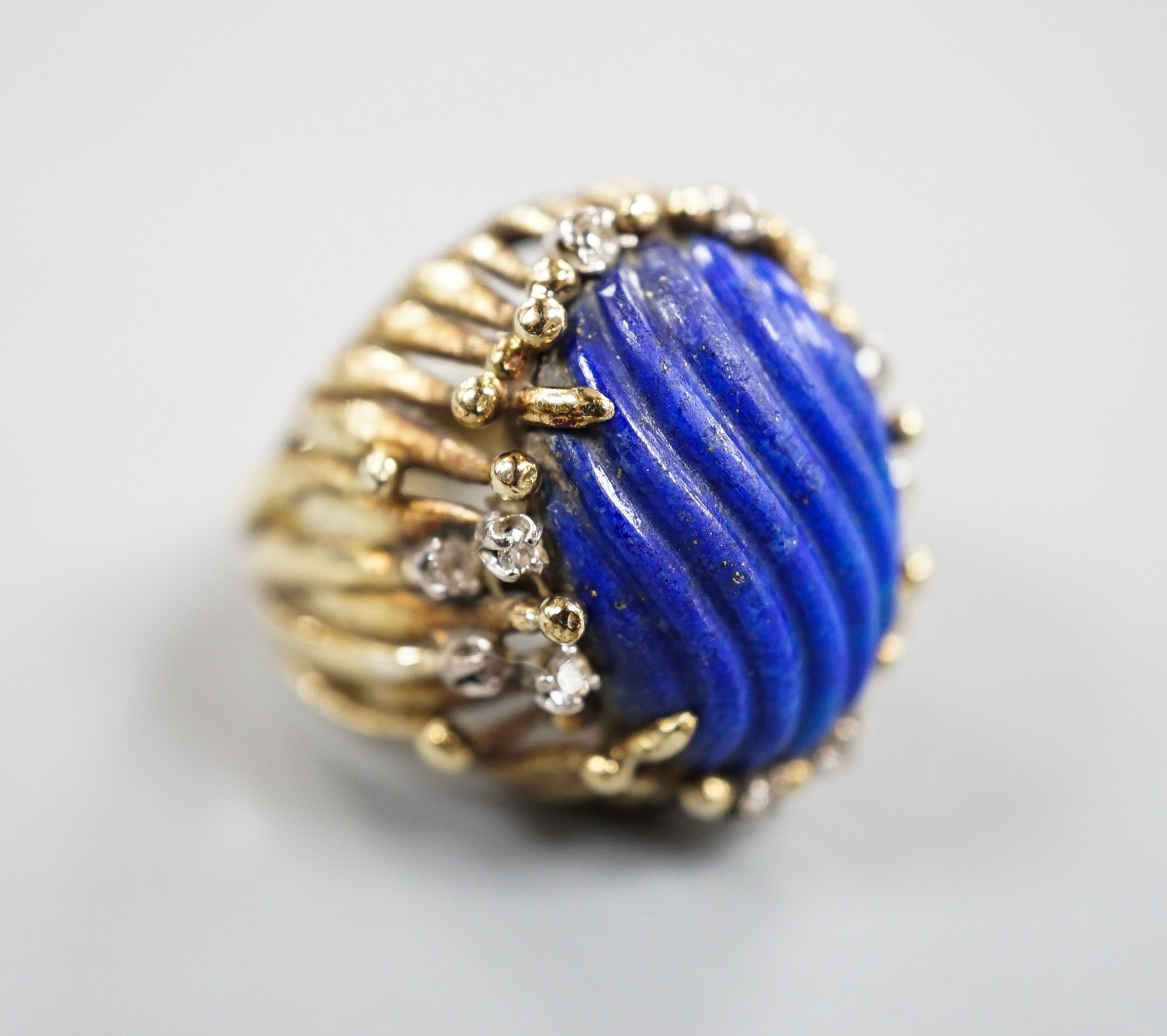 A pierced fluted 14k yellow metal, lapis lazuli and diamond set modernist dress ring, size K/L, gross weight 15.3 grams.
